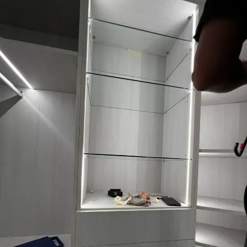 Custom closet with glass shelves and LED lighting