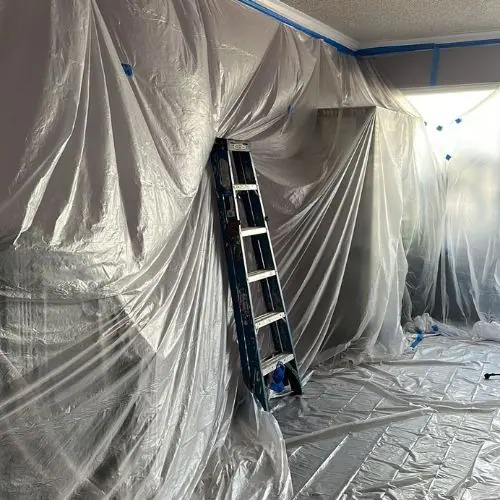 Room masked with plastic sheeting ready for spray painting